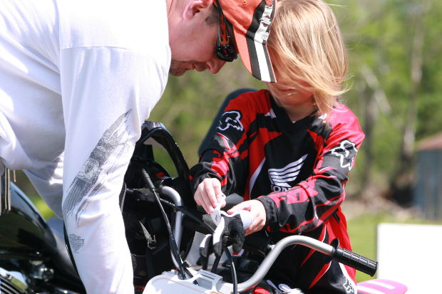 dad gets daughter ready for biking